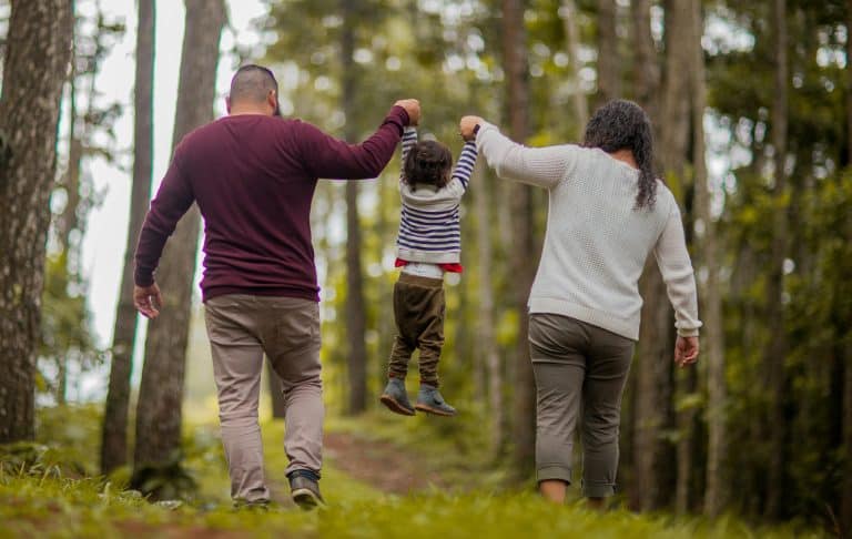 Family walking through woods